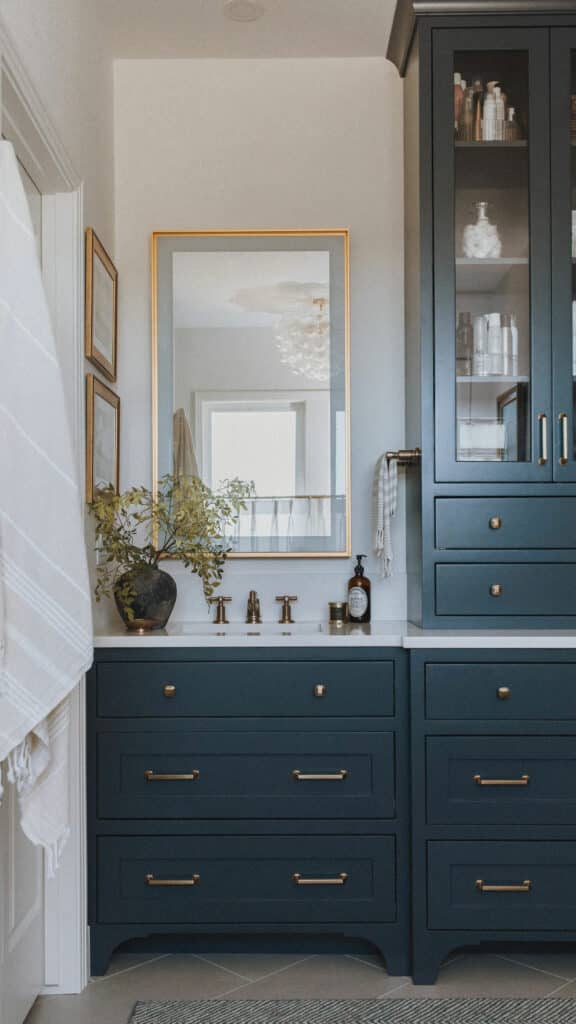 Painted maple inset vanity by Harris Timberworks in Niwot CO with brass pulls, in-drawer outlets, and traditional furniture-style cabinetry detailing.
